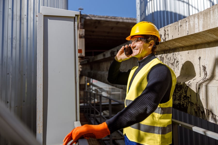 Engineer talking on the phone outside of the factory