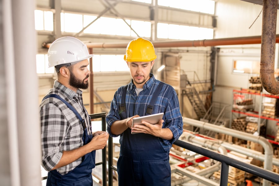  Two manufacturing workers looking at a tablet 