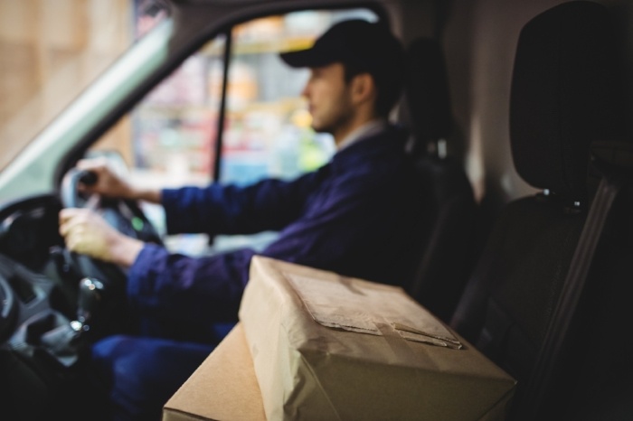 Delivery Driver Driving with Parcels on Seat