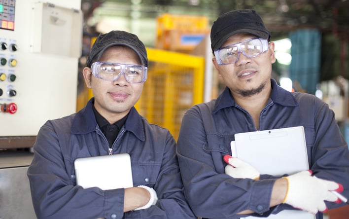 two_young_industrial_engineers_inside_factory